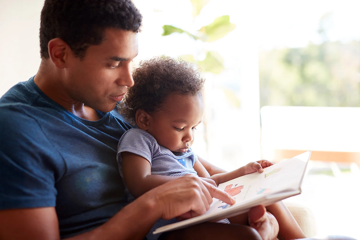 A father reading with his baby