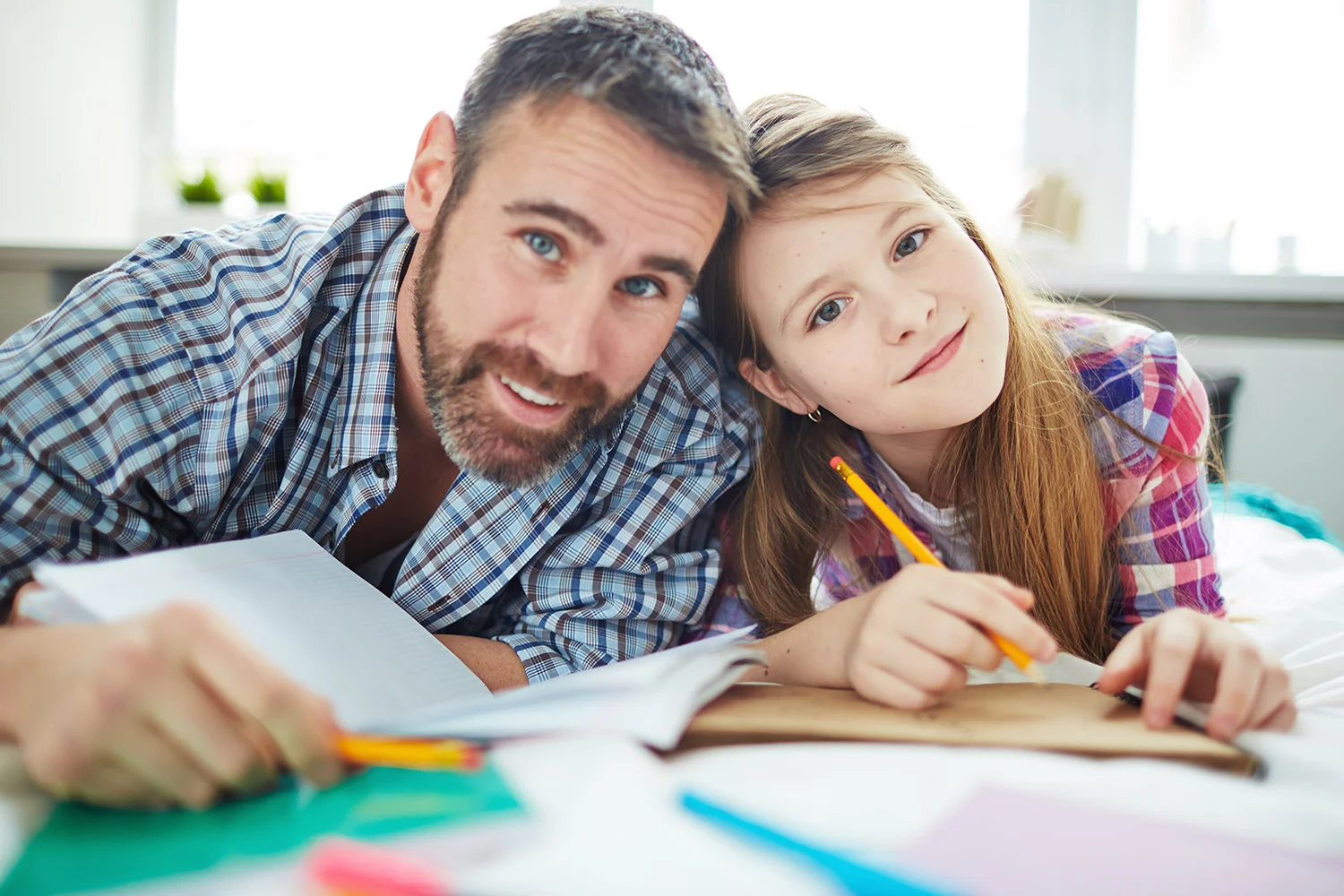 A father helping his daughter with schoolwork