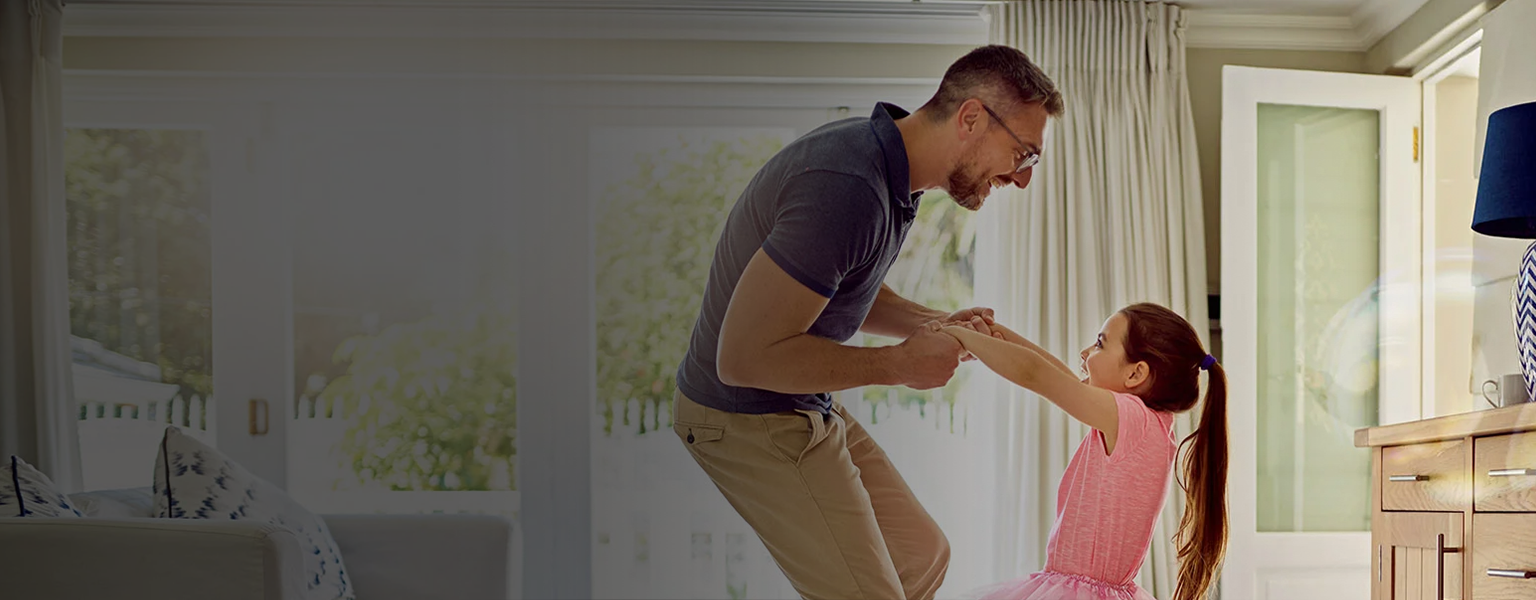 A father playing with his daughter at home