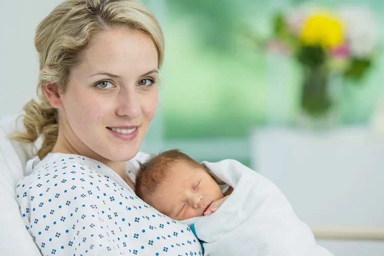 A mother holding her newborn baby