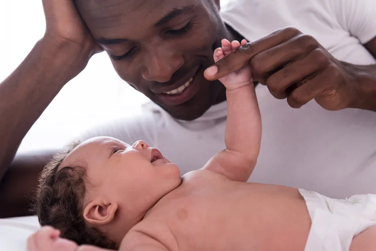 A father holding his baby's hand